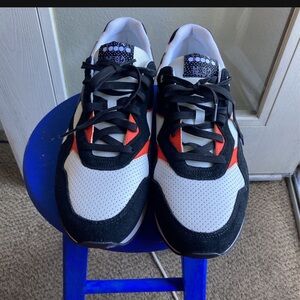 Stylish Black and White Sneakers with Red Accents Diadora